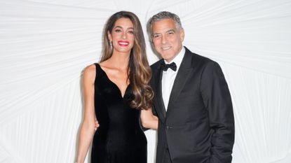 Amal Clooney and George Clooney pose together wearing black tie
