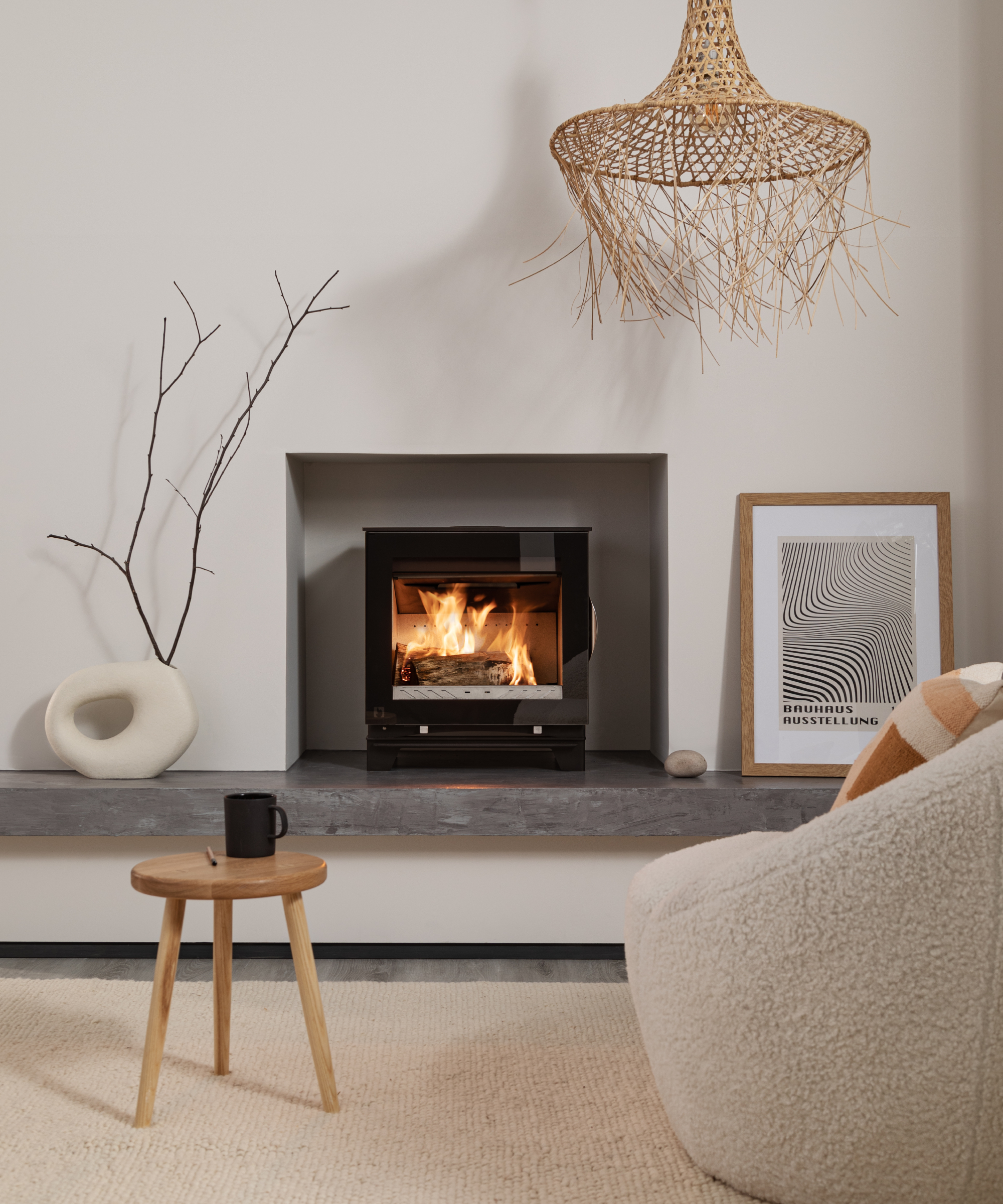 modern log burner set in hole in wall with slate raised hearth