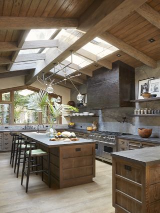 wood kitchen with skylight and dark marble worktops