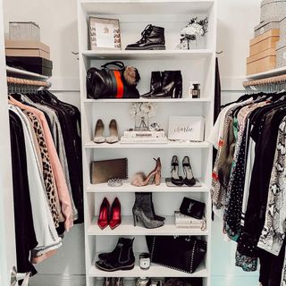 Closet with rails and central shelving unit with chic shoe display