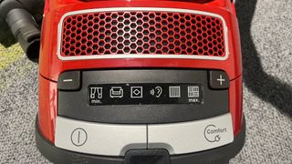 A close up of the controls of the Miele Complete C3 Cat and Dog Powerline Canister Vacuum