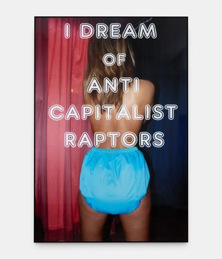 woman from behind, with words 'I dream of anti capitalist raptors' overlaid