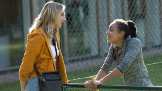 Ella Lily Hyland and Harmony Rose Bremner talk over a tennis net in Fifteen Love