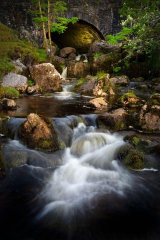 The Afon Clydach river in the Black Mountain in South Wales UK as it passes under a bridge on the A4069