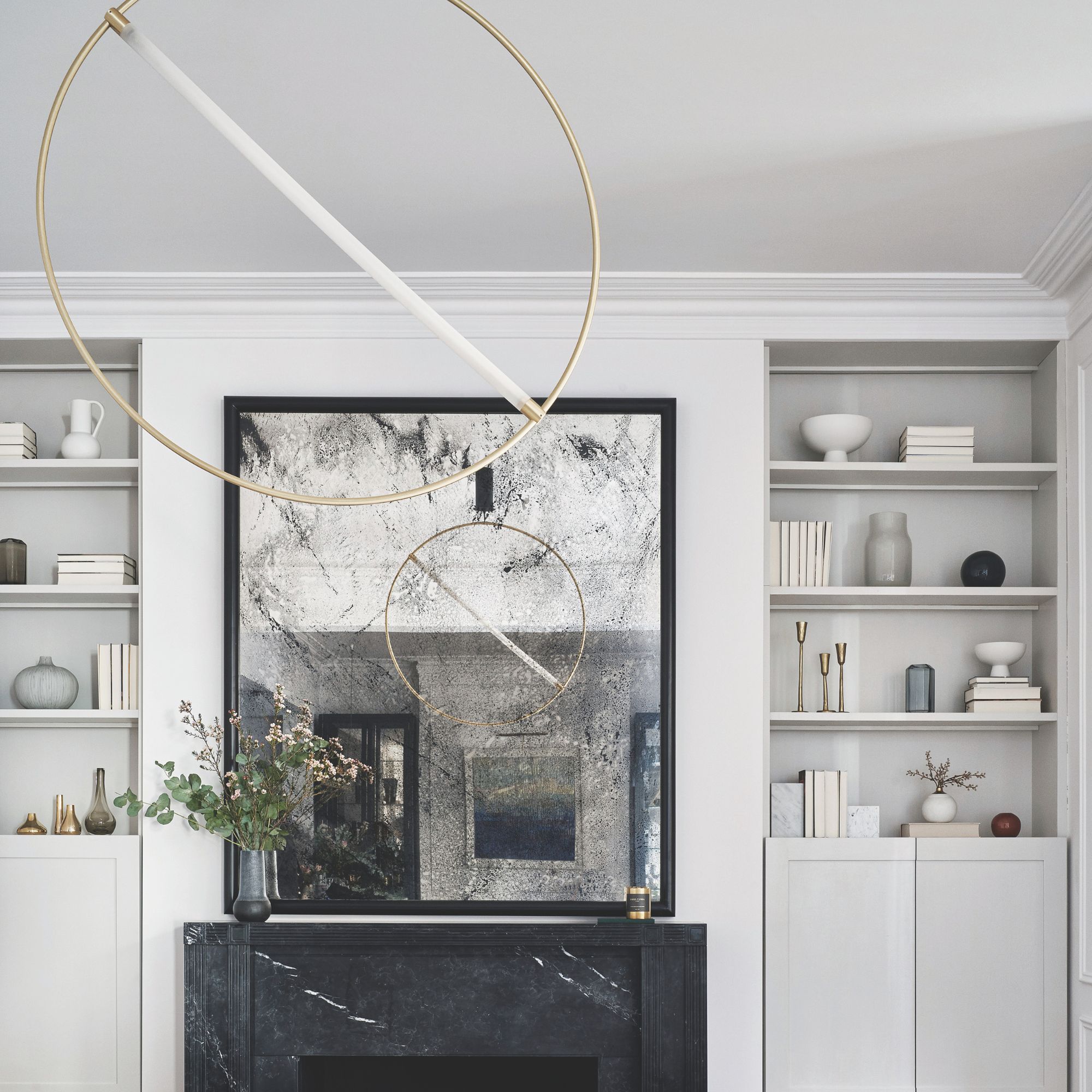 Minimalist living room with circle gold light and open shelving