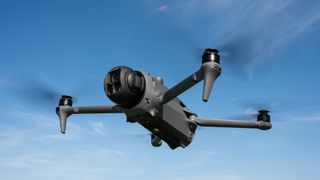 DJI Mavic 4 Pro in flight against a blue sky