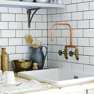 industrial kitchen with brass tap metro tiles