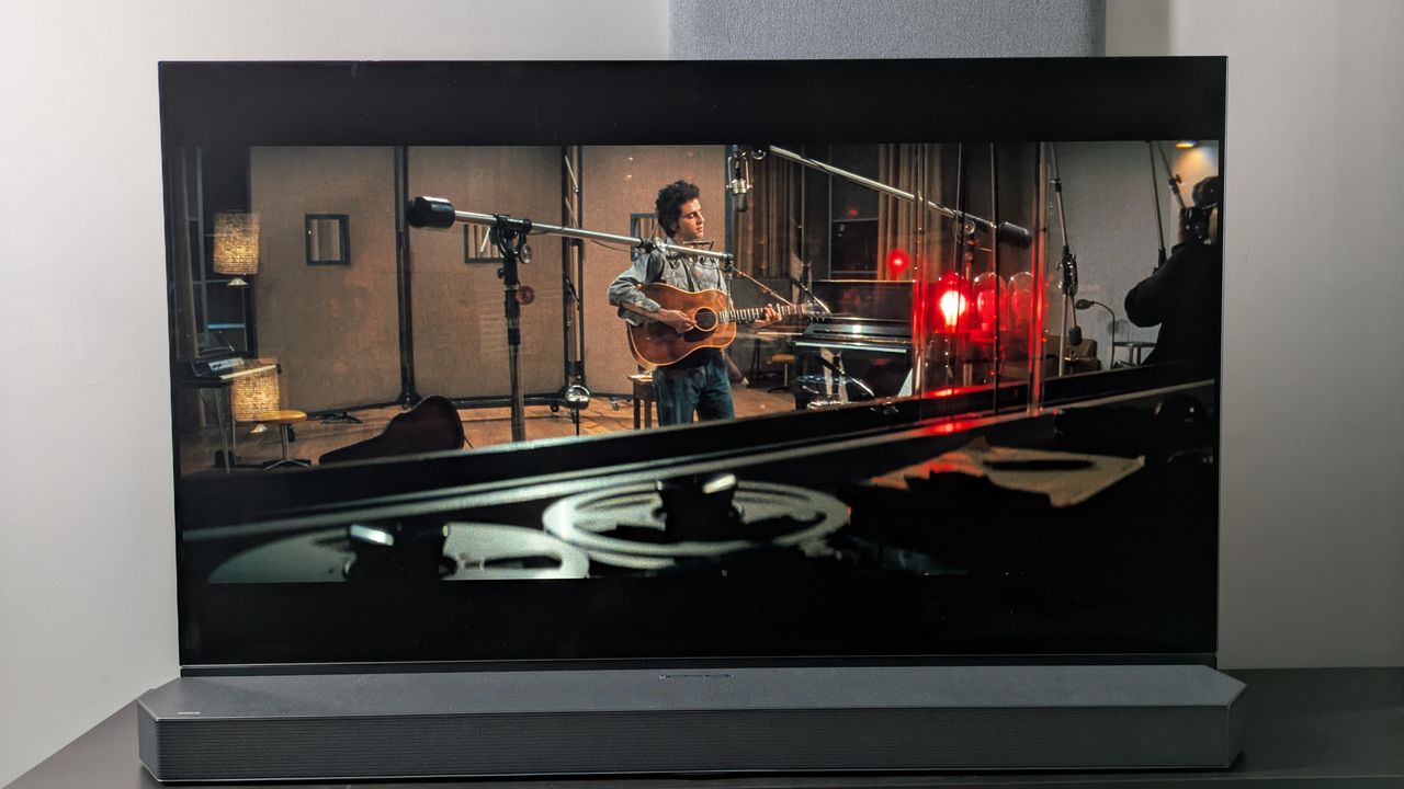 Panasonic OLED showing scene from A Complete Unknown with Timothee Chalamet as Bob Dylan in recording studio