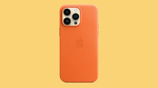 An iPhone 14 in one of the best iPhone 14 cases on an orange background