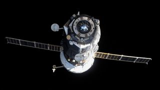 a black spacecraft with a white rear and extended solar arrays flies through the blackness of space