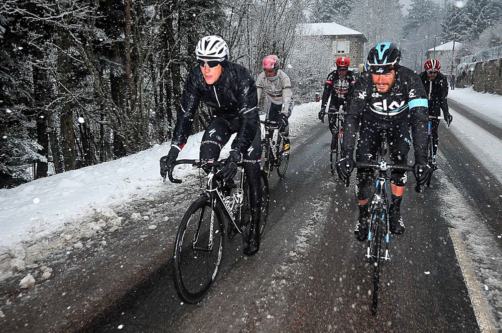 Niki Terpstra and Luke Rowe ride in the snow before the stage was canceled.