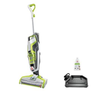 Bissell Crosswave Floor and Area Rug Cleaner,in white and green with black docking station and white bottle of cleaning fluid