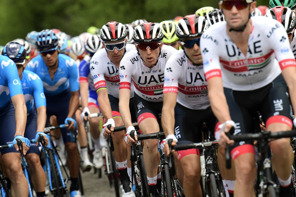 Dan Martin surrounded by UAE Team Emirates teammates.