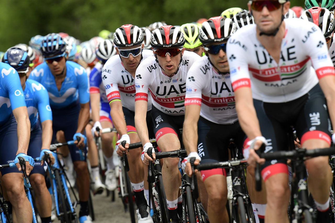 Dan Martin surrounded by UAE Team Emirates teammates.