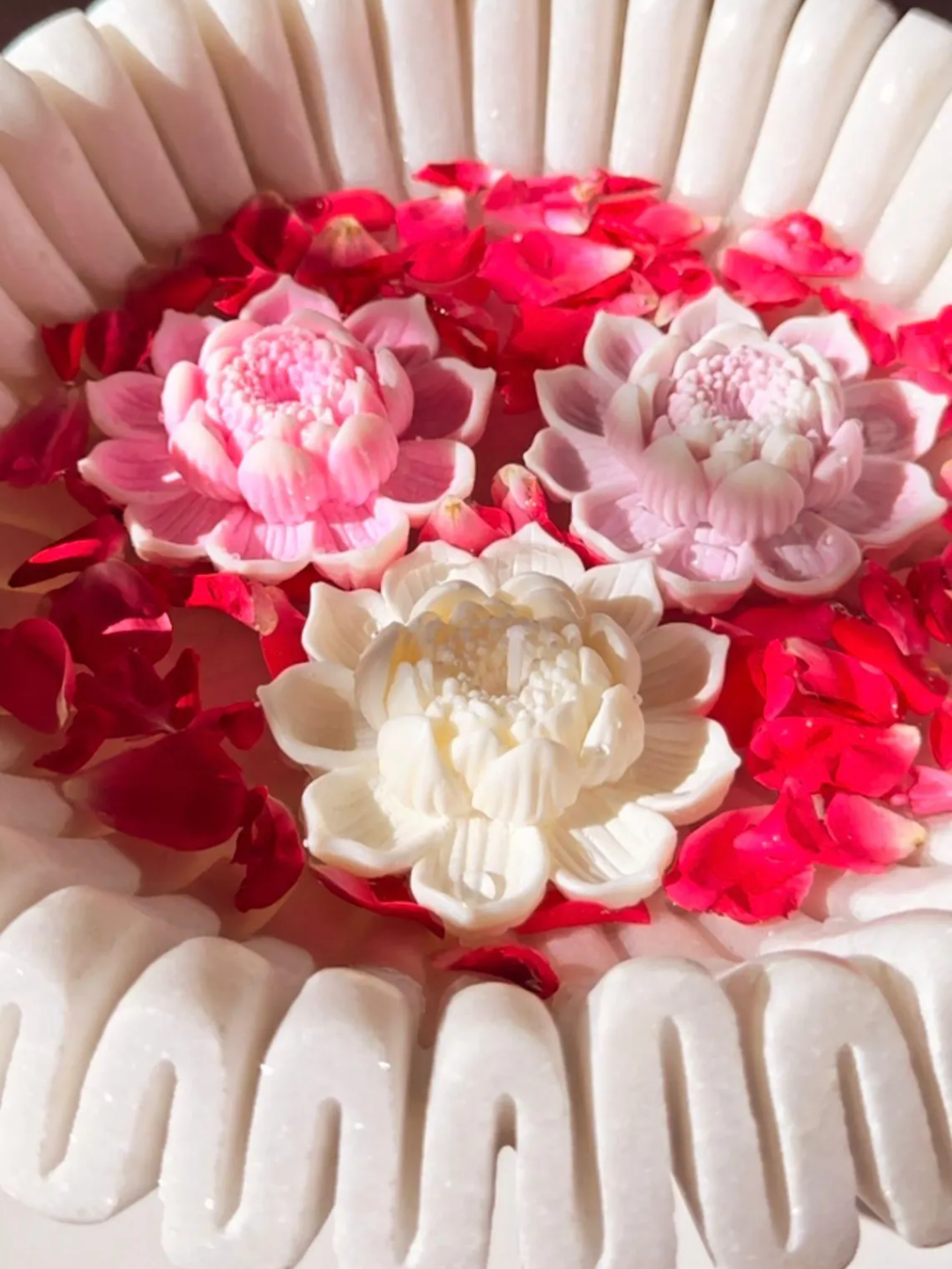 A bowl of floating lotus candles