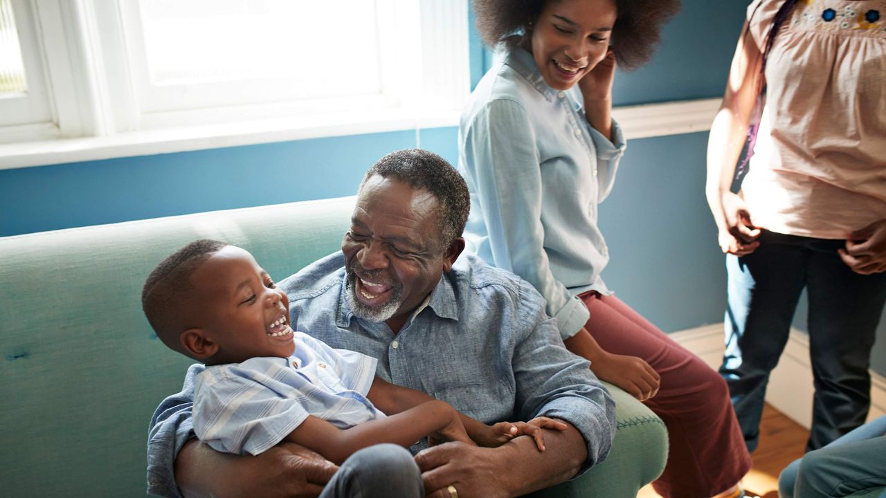 A grandfather plays with his grandkids.