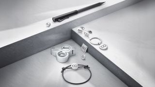 Selection of Leica 100th anniversary accessories on a geometric metal display