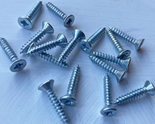 Silver screws scattered on a table