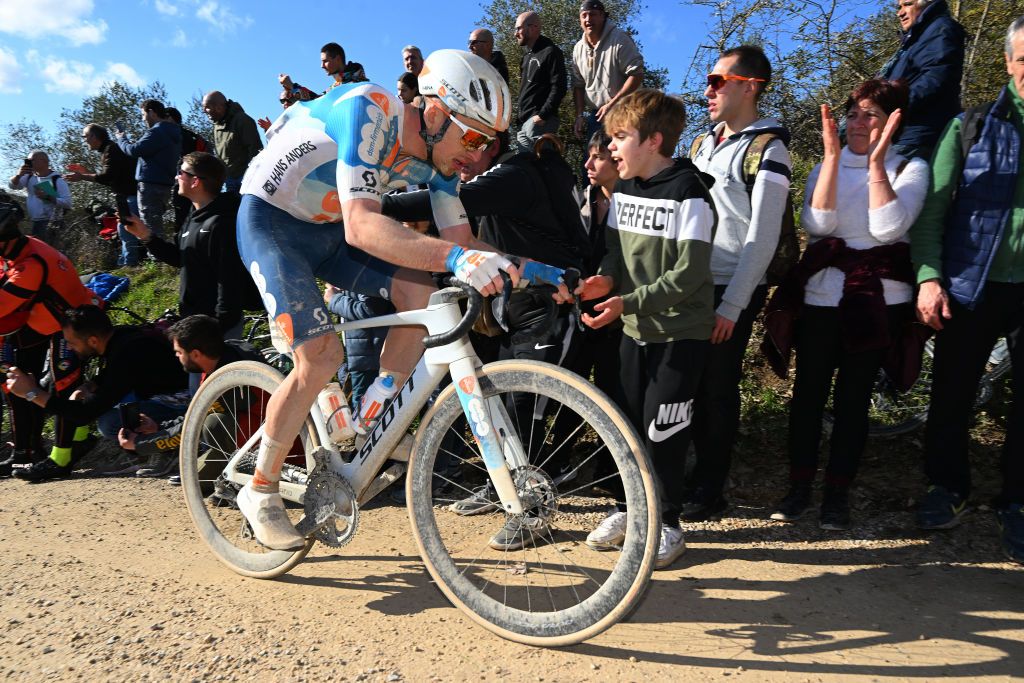 SIENA ITALY MARCH 02 Frank van den Broek of The Netherlands and Team dsmfirmenich PostNL competes while fans cheer during the 18th Strade Bianche 2024 Mens Elite a 215km one day race from Siena to Siena 320m UCIWT on March 02 2024 in Siena Italy Photo by Tim de WaeleGetty Images