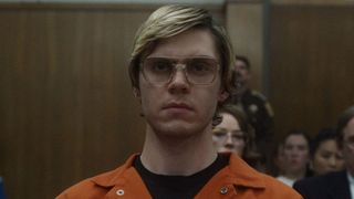 Evan Peters as Jeffrey Dahmer sitting in a court room during the Netflix show Dahmer - Monster: The Jeffrey Dahmer Story.