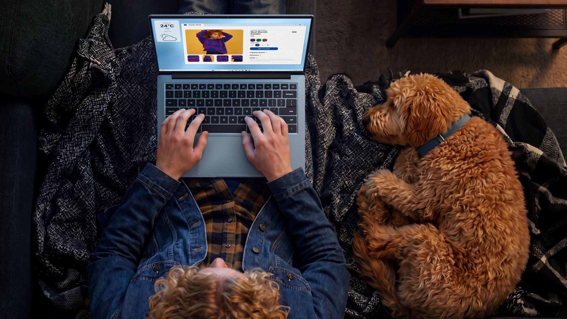 Dell 14S laptop being used by a person sat on a sofa on their lap, top-down view, a dog is curled up asleep next to them