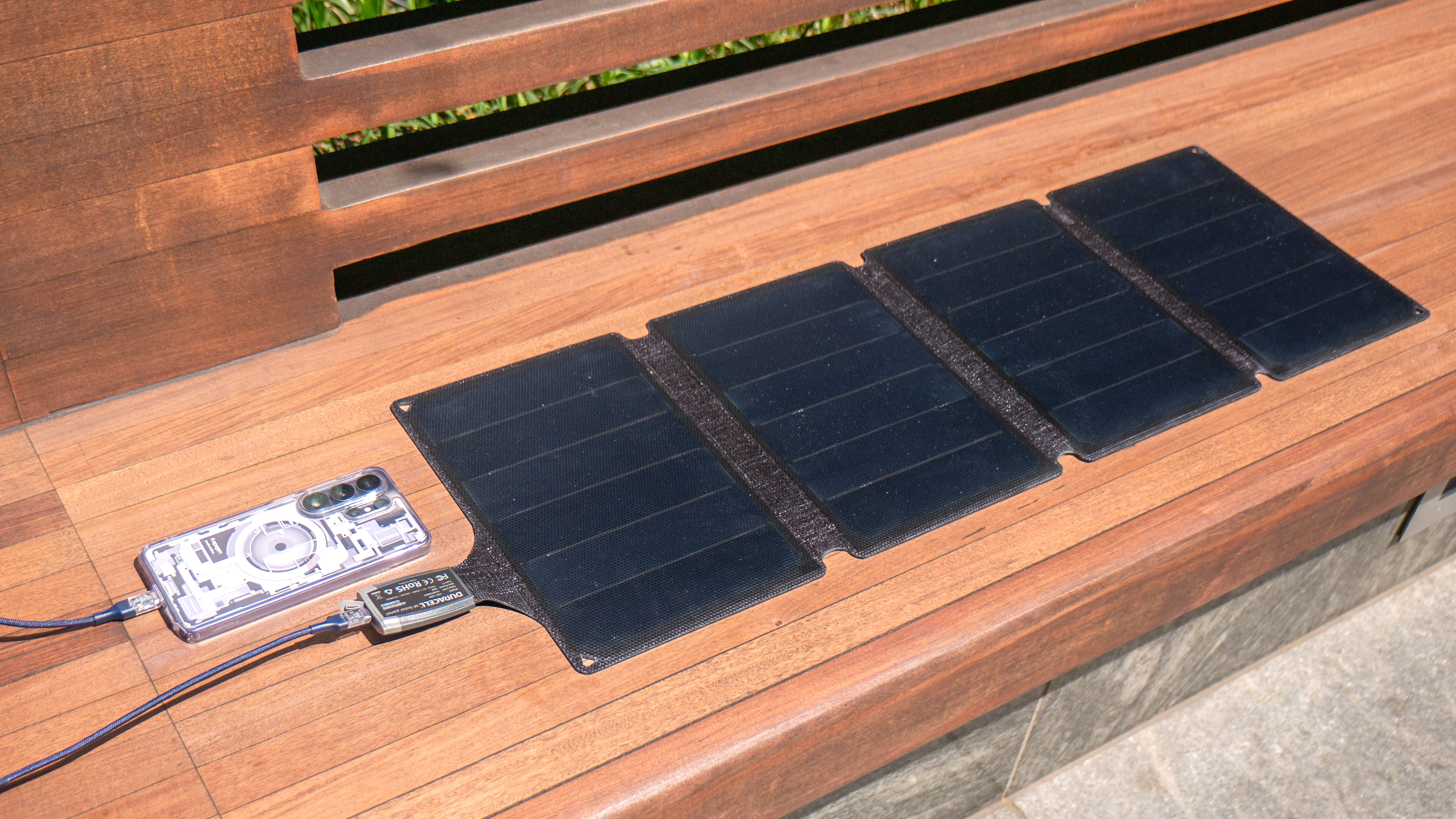Duracell M-Series Portable Solar Panel charging a phone.