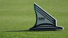 A Dubai Invitational tee marker