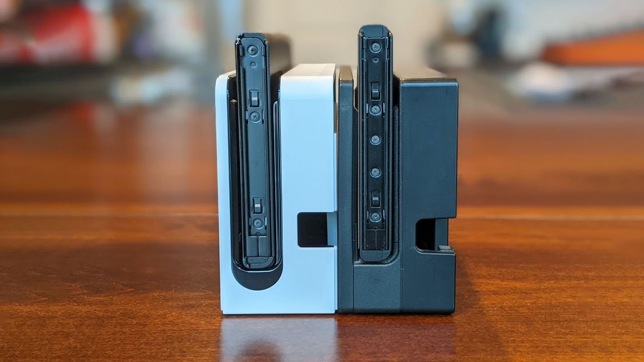 Nintendo Switch Oled Model And V2 Docks Next To Eachother Other Side