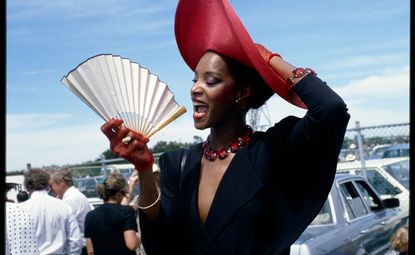 Photo 2024 preview image: woman with hat and fan