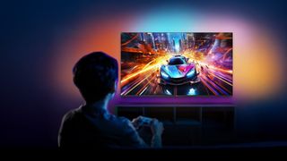 Lifestyle image of the Roku Philips Ambilight TV shot from behind someone playing a video game with a sports car in it and lots of colors on the wall