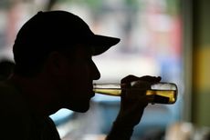 Man drinking beer at a bar