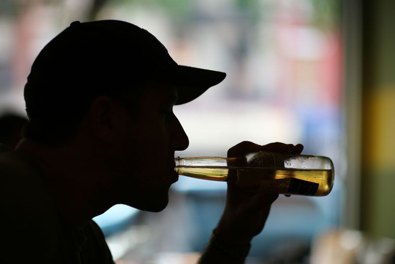 Man drinking beer at a bar