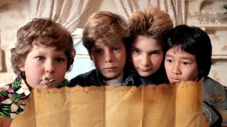 Chunk, Mikey, Mouth and Data read a treasure map in The Goonies.