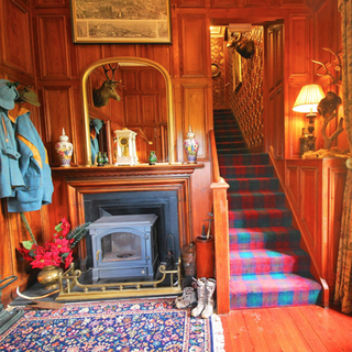 dall house with staircase and tartan carpets