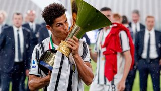 Cristiano Ronaldo kisses the Serie A trophy after Juventus won the 2020 Italian League season.