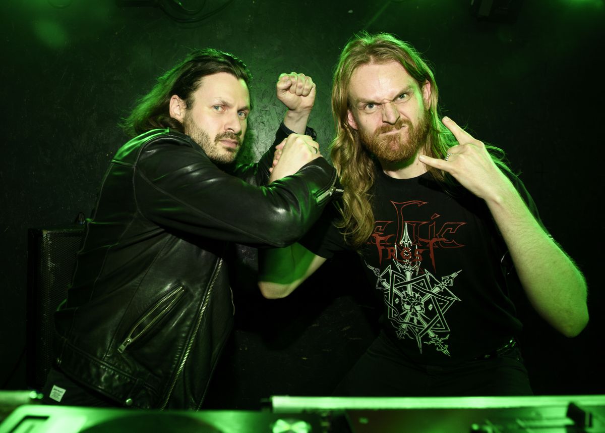 People drinking, smiling and throwing horns at the Metal Hammer 400 party