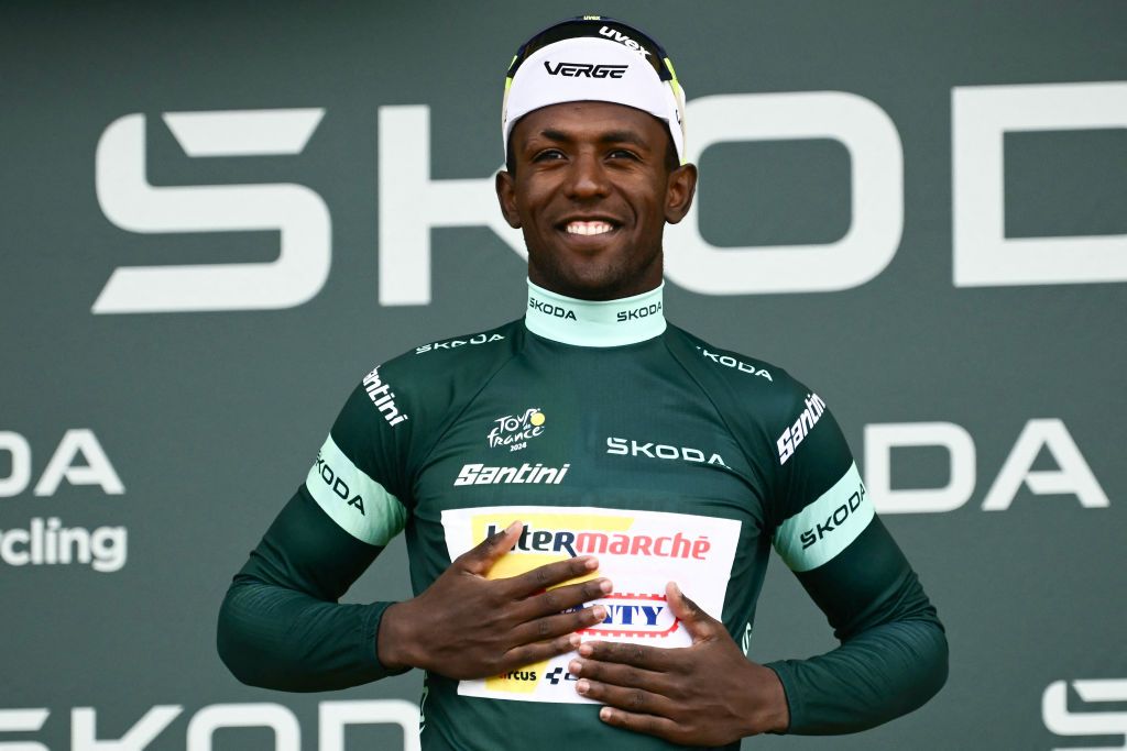 Intermarche - Wanty team's Eritrean rider Biniam Girmay celebrates on the podium with the best sprinter's green jersey after the 8th stage of the 111th edition of the Tour de France cycling race, 183,5 km between Semur-en-Auxois and Colombey-les-deux-Eglises, on July 6, 2024. (Photo by Marco BERTORELLO / AFP)