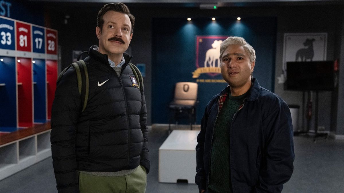 Ted and Nate looking up at where the Believe sign would be in the AFC Richmond locker room.