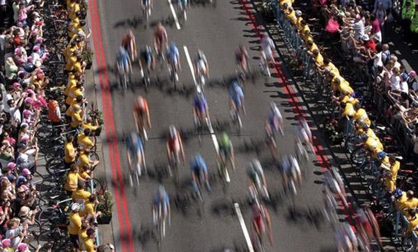 The riders cross the Tower Bridge to a big crowd of fans