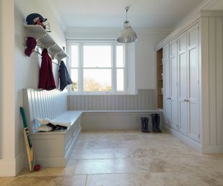 neutral coloured boot room with seating along one wall