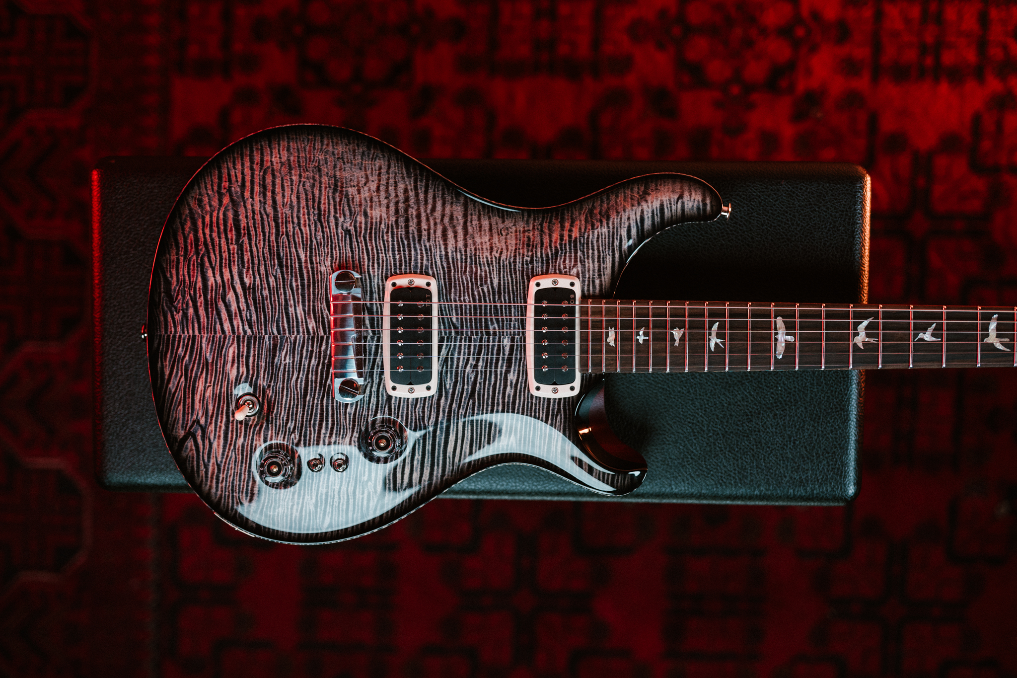 PRS's Charcoal Phoenix guitar sits atop a guitar case