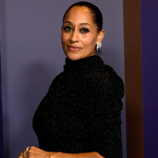 Tracee Ellis Ross wearing a smoky eyeshadow look and a slicked back bun.