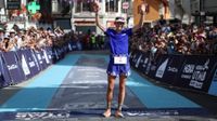 US' athlete Katie Schide gestures as she celebrates victory while crossing the finish line at the end of the Ultra-Trail du Mont Blanc (UTMB) women's race in Chamonix