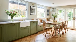 pale green kitchen with built in bench seating