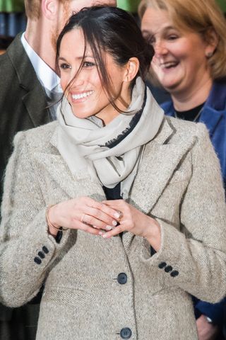 US actress Meghan Markle waves to well-wishers as they leave after a visit to Reprezent 107.3FM community radio station in Brixton, south west London