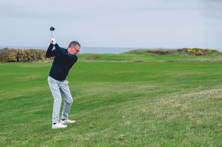 Steve North in his backswing while hitting a fairway wood shot from the rough on the 10th hole at Trump Turnberry