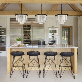 kitchen with chandeliers and bar stools