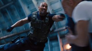 Dwayne Johnson flies into the air with his arm stretched out for a clothesline attack in Fast & Furious 6