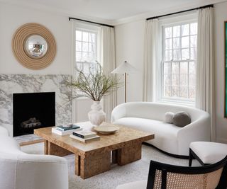Living room with large coffee table and round white sofa
