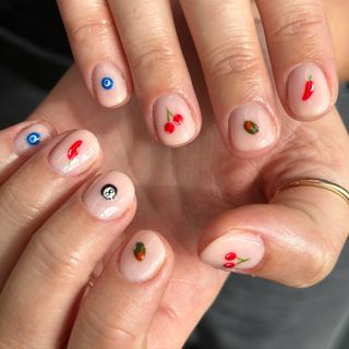 Mixed nail art with evil eye, chillies, cherries and olive micro nail art